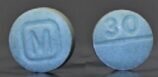 Both sides of a light blue fake M30 Oxycodone pill that contains fentanyl.